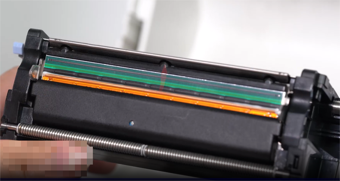 Una close-up of a person carefully cleaning an electronic component with a swab.